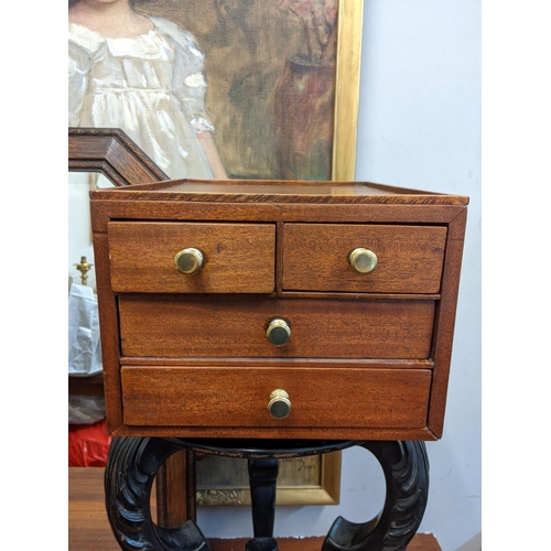 40 - An early 20th century black painted plant stand and a mahogany four-drawer chest containing cutlery ... 