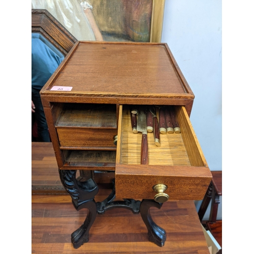 40 - An early 20th century black painted plant stand and a mahogany four-drawer chest containing cutlery ... 