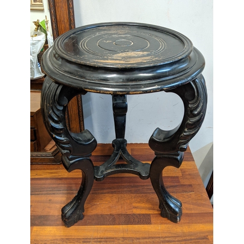 40 - An early 20th century black painted plant stand and a mahogany four-drawer chest containing cutlery ... 