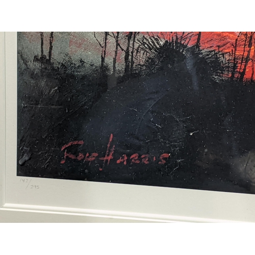 409 - A Rolf Harris limited edition print 142/295 titled New Dawn depicting a sunrise/sunset through exoti... 