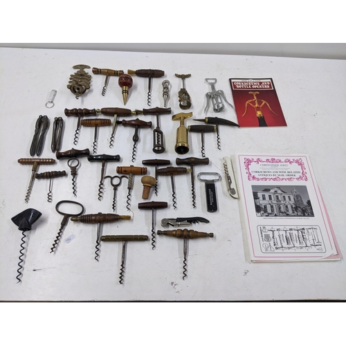 416 - A collection of vintage corkscrews and bottle openers to include a Cognac Courvoisier brass example,... 