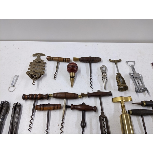 416 - A collection of vintage corkscrews and bottle openers to include a Cognac Courvoisier brass example,... 