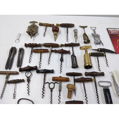 416 - A collection of vintage corkscrews and bottle openers to include a Cognac Courvoisier brass example,... 