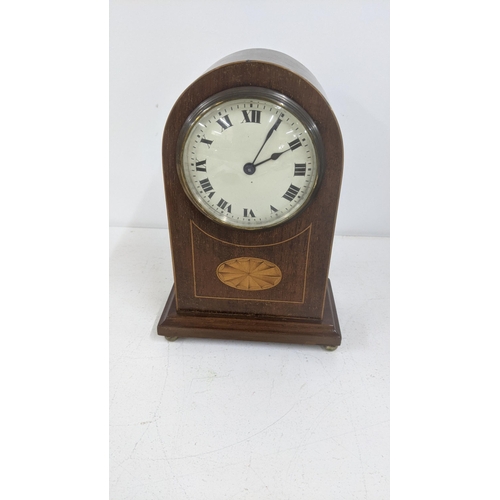 431 - An early to mid 20th century mahogany fan inlaid mantel clock with a Swiss buren cylinder drum movem... 