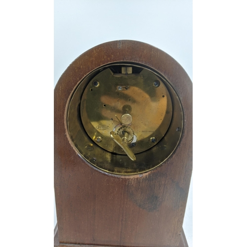 431 - An early to mid 20th century mahogany fan inlaid mantel clock with a Swiss buren cylinder drum movem... 