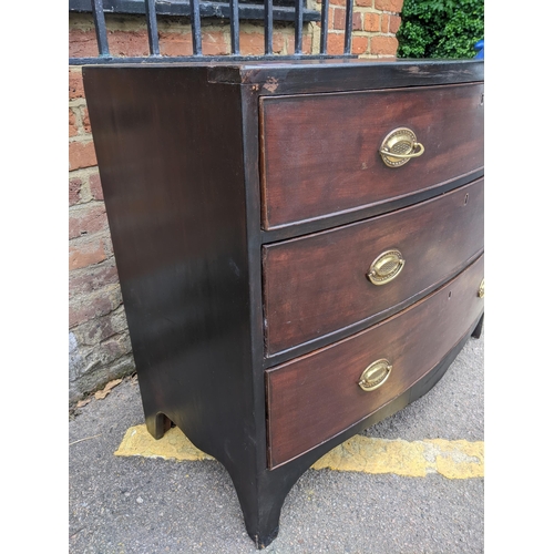 466 - A Georgian mahogany bow fronted chest of three graduated drawers with brass handles, on bracket feet... 