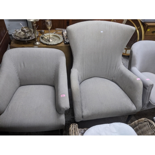 474 - Two similar contemporary His and Her armchairs in matched upholstered, one with splayed front legs, ... 