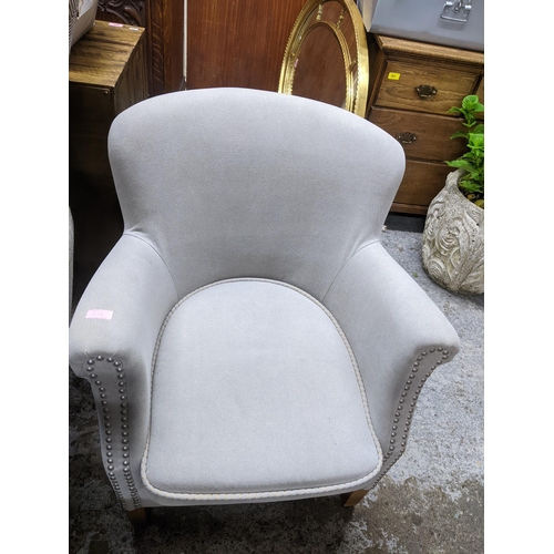 474 - Two similar contemporary His and Her armchairs in matched upholstered, one with splayed front legs, ... 