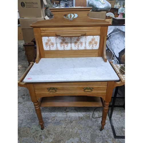 475 - Edwardian ash and marble topped washstand, the extended back with single shelf above a four tile pan... 