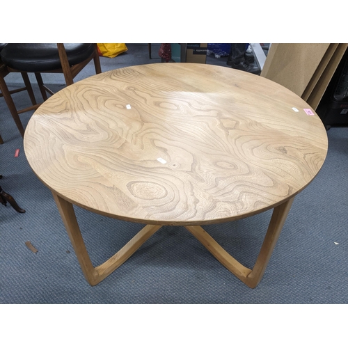 476 - An Ercol Wychwood design circular elm coffee table on square legs united on shaped stretchers 49.5cm... 