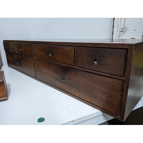 481 - A group of desktop and other wooden items to include a mahogany bank of six drawers with inset brass... 