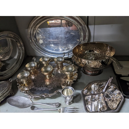 69 - A selection of silver plated items to include a punch bowl and cups with ladle, circular Sheffield p... 