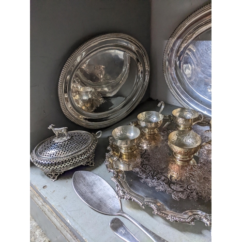 69 - A selection of silver plated items to include a punch bowl and cups with ladle, circular Sheffield p... 