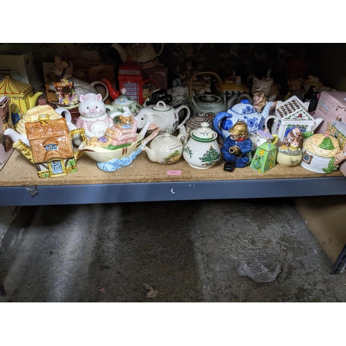 71 - A collection of novelty teapots, some boxed, to include a red telephone box teapot, and others Locat... 