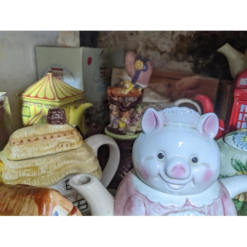 71 - A collection of novelty teapots, some boxed, to include a red telephone box teapot, and others Locat... 