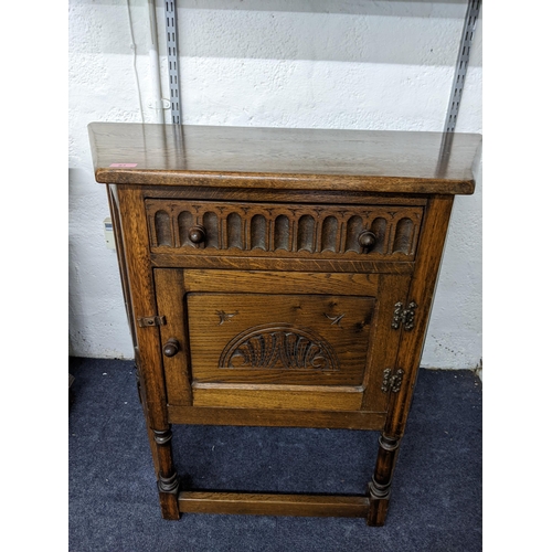 83 - A carved oak side cabinet on turned legs  and square stretchers, 83 x91.5x44.5cms
Location: A2F
If t... 