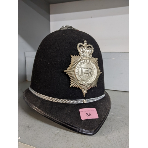 85 - A Hertfordshire constabulary policeman's helmet and county hat badge and rosette
Location: RAM
If th... 