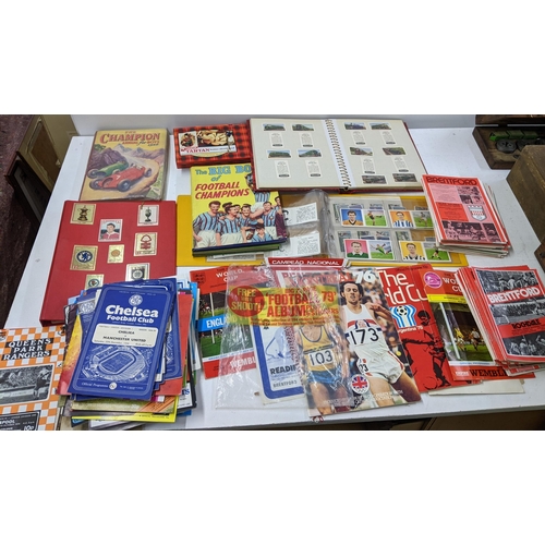 29 - A collection of sporting related printed items to include various football programmes, collectors ca... 