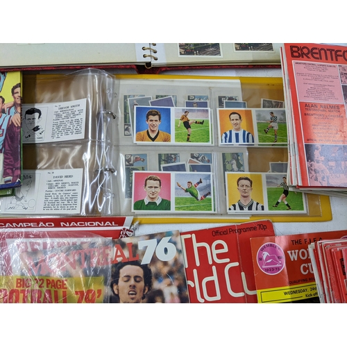 29 - A collection of sporting related printed items to include various football programmes, collectors ca... 