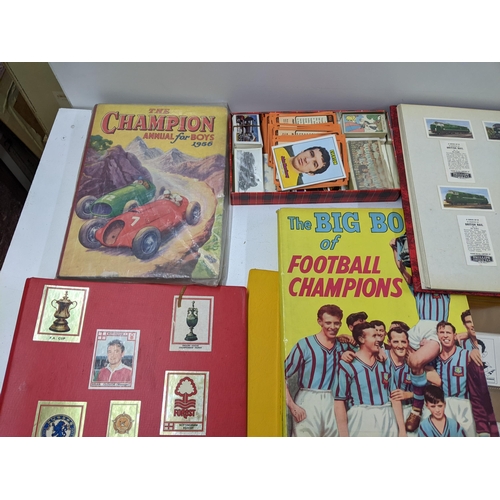 29 - A collection of sporting related printed items to include various football programmes, collectors ca... 