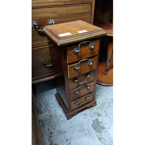 334 - A reconstituted mahogany table top chest of five drawers Location:
If there is no condition report s... 