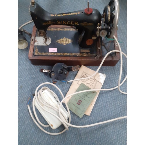 337 - A 1929 99k Singer electric sewing machine A/F, serial number Y695604 having a domed case and oak bas... 