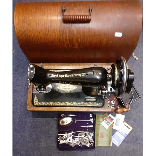 336 - A 1937 Singer 99K sewing machine, serial no:EB676629 with manual and accessories under an oak domed ... 