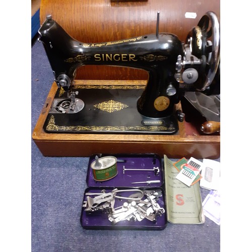 336 - A 1937 Singer 99K sewing machine, serial no:EB676629 with manual and accessories under an oak domed ... 