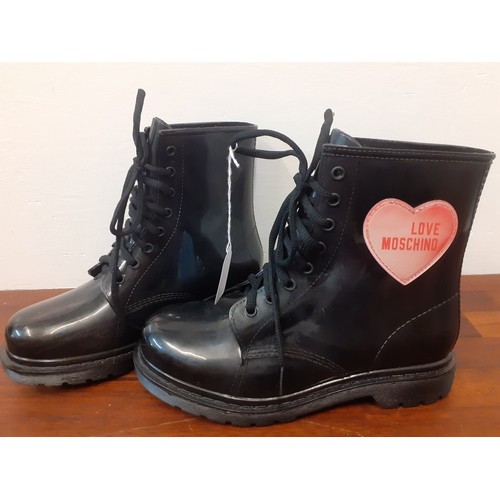 20 - Moschino- A pair of 'Love Moschino' ladies black rubber and lace-up ankle boots with branded heart h... 