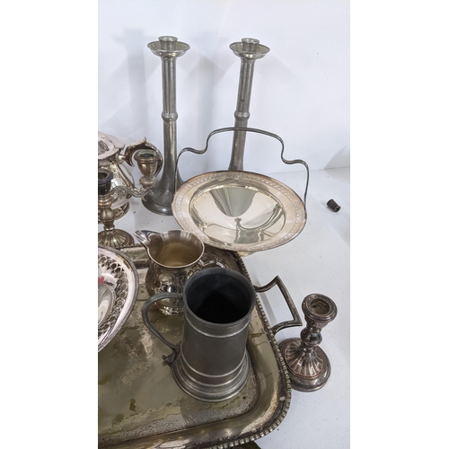 338 - A mixed lot of metalware to include a silver plated tray, Arts & Crafts pewter candlesticks and othe... 