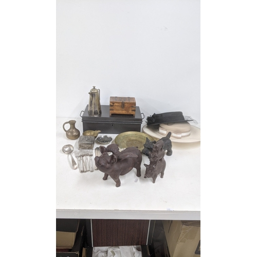 438 - A mixed lot to include a cast metal pig with wings and others, a decorative brass dish with floral e... 