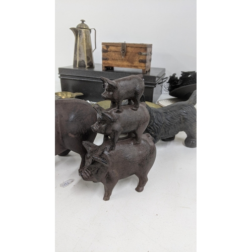 438 - A mixed lot to include a cast metal pig with wings and others, a decorative brass dish with floral e... 