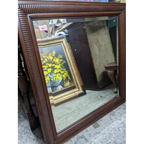 492 - A contemporary wooden framed wall mirror with fluted decoration, square bevelled glass plate 81.5cm ... 