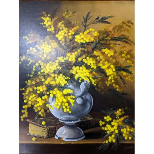 493 - J Roy - still life porcelain vase of yellow Mimosa blossoms by a leatherbound book, oil painting on ... 