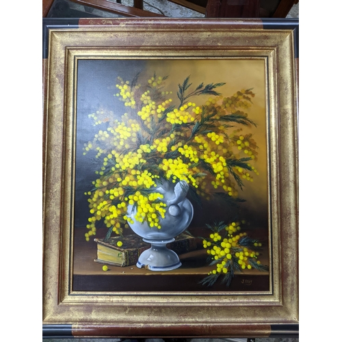 493 - J Roy - still life porcelain vase of yellow Mimosa blossoms by a leatherbound book, oil painting on ... 