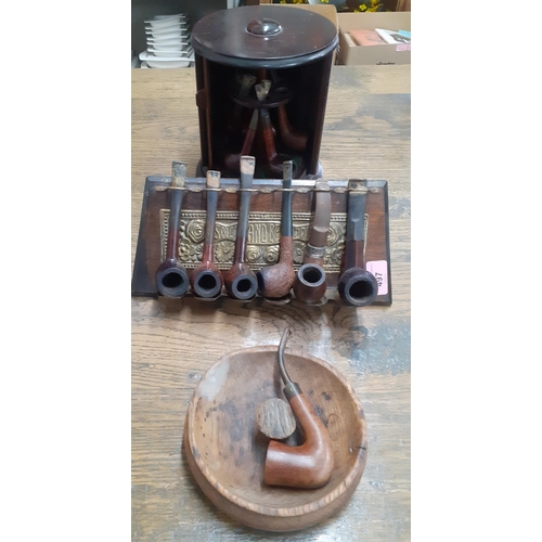 497 - A quantity of vintage pipes, a revolving pip stand and another stand and an oak ashtray
Location: RA... 