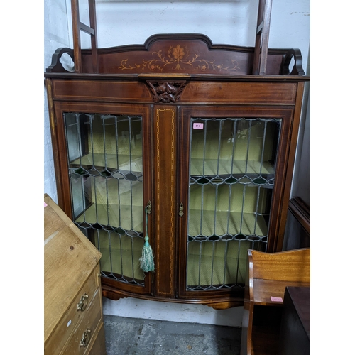 514 - A late Victorian inlaid mahogany bow fronted display cabinet, 3/4 galleried top with inlaid floral d... 