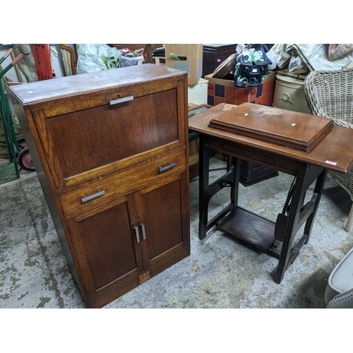 517 - A Jones Family C S Treadle sewing machine housed in a walnut framed table 83cm x 85cm x 45.5cm, alon... 