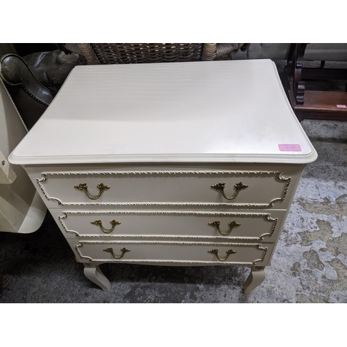 518 - A mid-century cream painted kidney shaped dressing table with triptych swing mirror above a central ... 