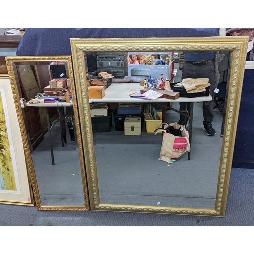 526 - Two reproduction gilt framed wall hanging mirrors one 137cm h x 107cm w, the other 125.5cm h x 44cm ... 