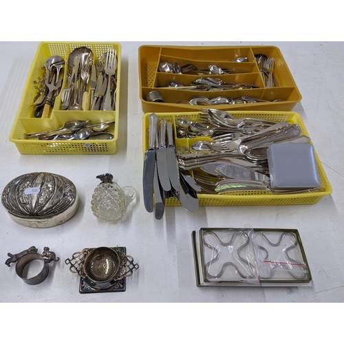 540 - Silver coloured items to include a hallmarked silver collared decanter, three trays of various flatw... 