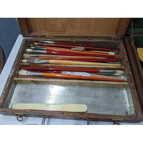 560 - Artist's equipment to include five handled cases containing paint, pencils, brushes, oils and other ... 