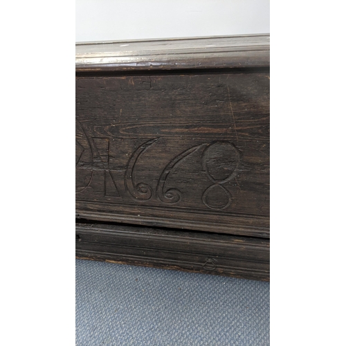 569 - A 17th century oak coffer with a candle tray and lower drawer with an engraved panel 1668 55cm h x 1... 