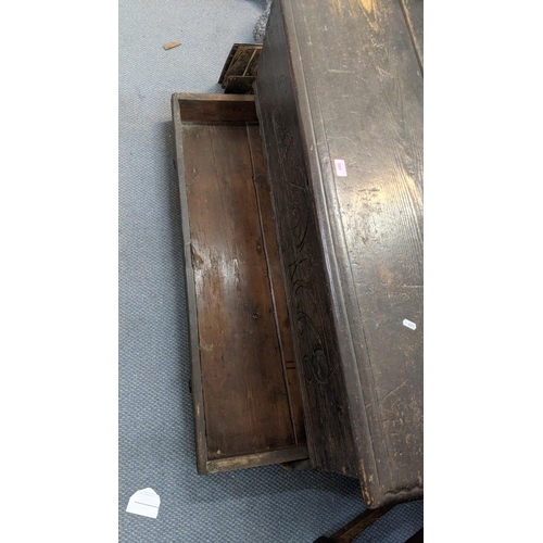 569 - A 17th century oak coffer with a candle tray and lower drawer with an engraved panel 1668 55cm h x 1... 