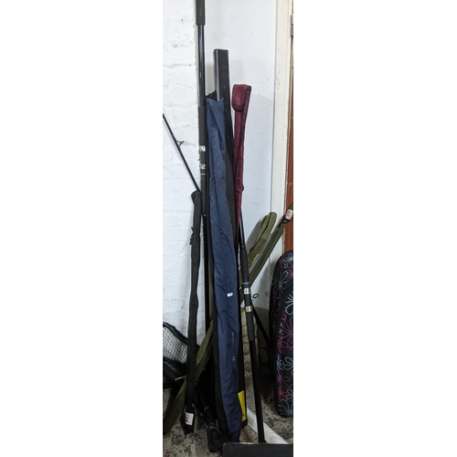 581 - A selection of fishing gear and equipment to include various vintage fishing rods including a Leeda ... 