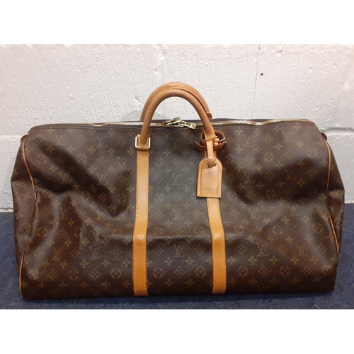 4 - Louis Vuitton-An LV monogram keepall 60 canvas bag, leather trimmed with double leather handles and ... 