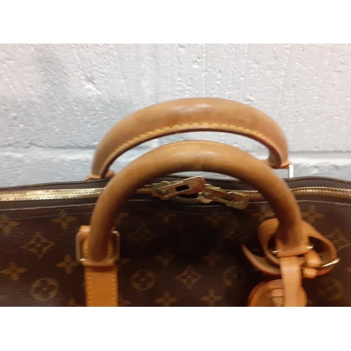 4 - Louis Vuitton-An LV monogram keepall 60 canvas bag, leather trimmed with double leather handles and ... 