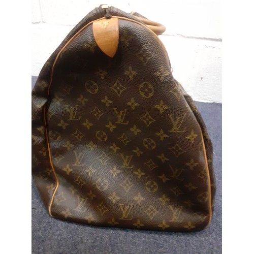 4 - Louis Vuitton-An LV monogram keepall 60 canvas bag, leather trimmed with double leather handles and ... 