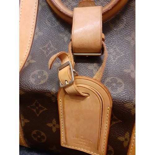 4 - Louis Vuitton-An LV monogram keepall 60 canvas bag, leather trimmed with double leather handles and ... 