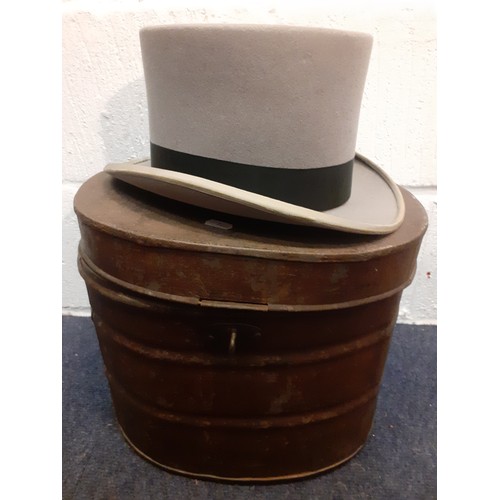 233 - A vintage metal hat box and a Best Quality grey top hat with black band, approx 60cm internal circum... 